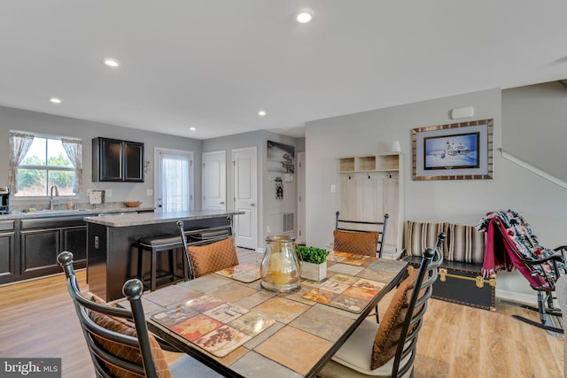 dining room with sink and light hardwood / wood-style flooring