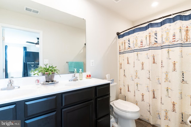 bathroom featuring hardwood / wood-style flooring, vanity, a shower with shower curtain, and toilet