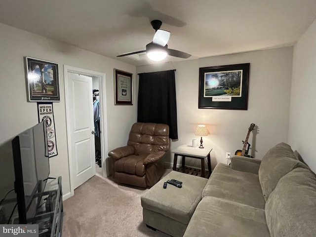 carpeted living room with ceiling fan