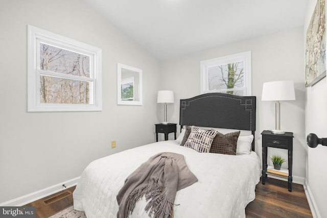 bedroom with dark wood-type flooring and vaulted ceiling