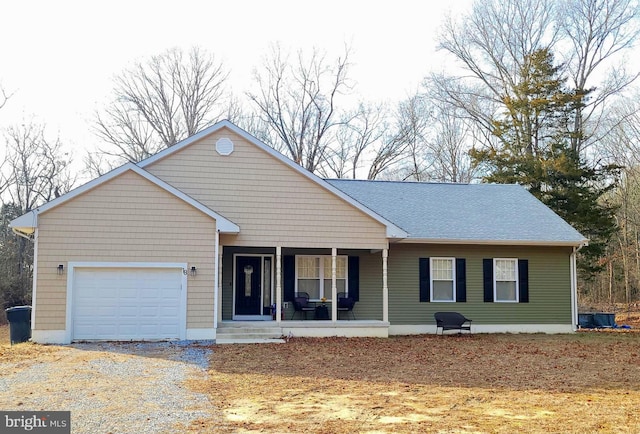 ranch-style home featuring a garage and covered porch