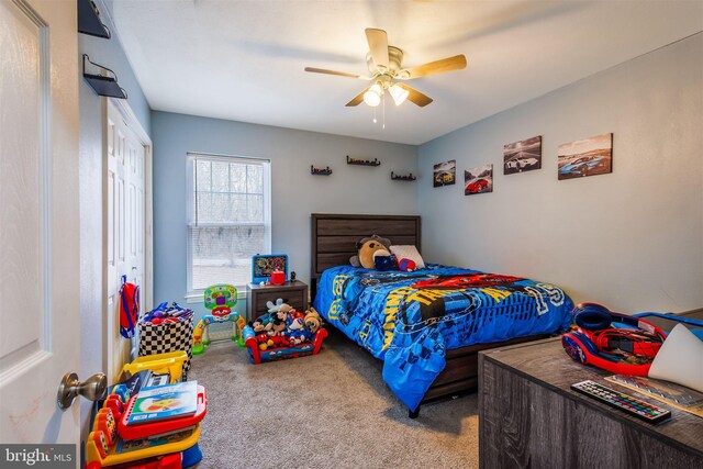 carpeted bedroom with a closet and ceiling fan