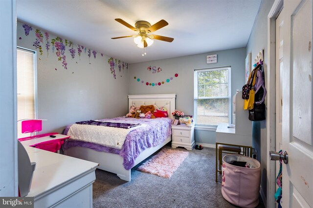 bedroom with ceiling fan and dark colored carpet