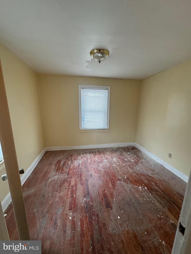 unfurnished room with hardwood / wood-style flooring