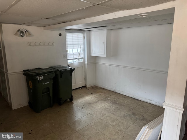 basement with a paneled ceiling