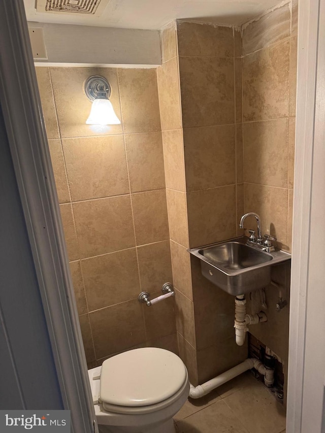 bathroom featuring tile patterned floors, toilet, and sink