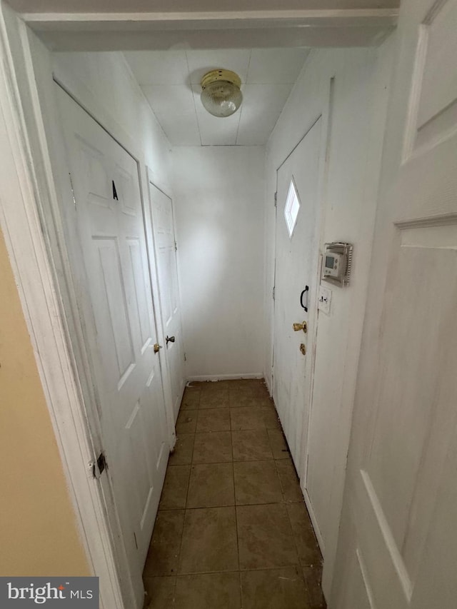 corridor with dark tile patterned flooring