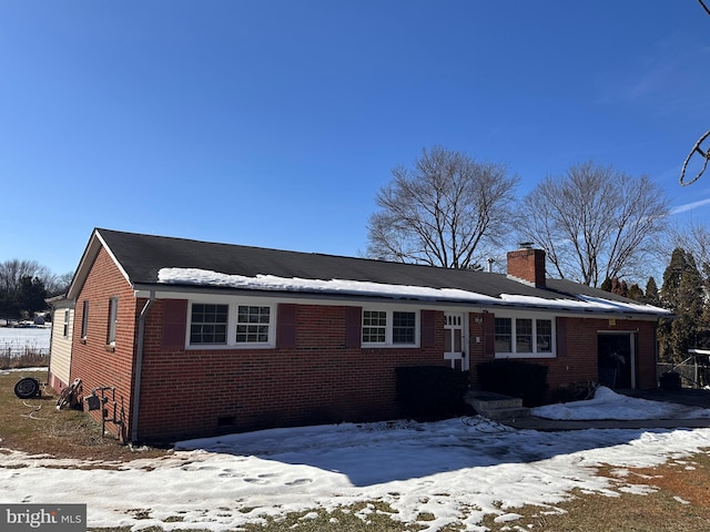 single story home with crawl space, brick siding, and a chimney