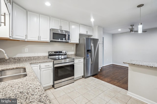 kitchen featuring white cabinetry, appliances with stainless steel finishes, and a sink