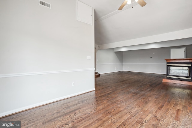 unfurnished living room with a ceiling fan, baseboards, visible vents, and wood finished floors