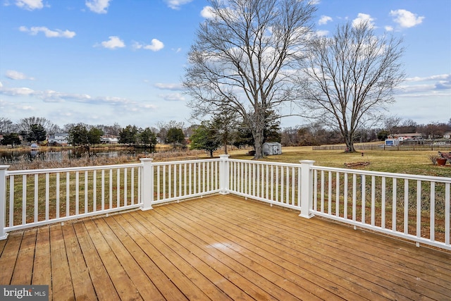 deck featuring a yard, an outdoor structure, and a storage unit