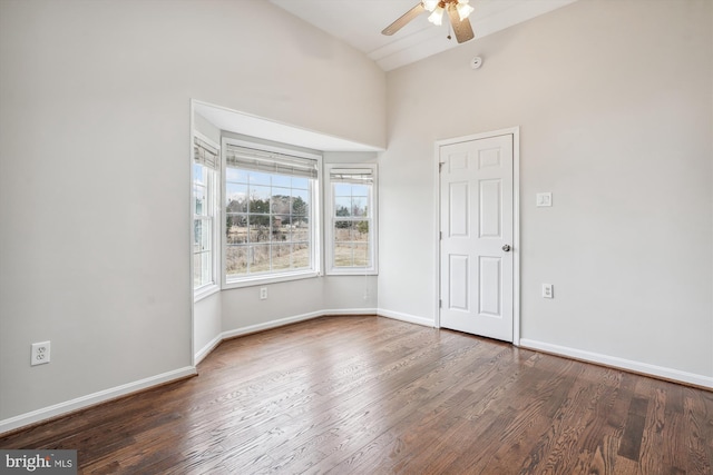 spare room with ceiling fan, wood finished floors, lofted ceiling, and baseboards