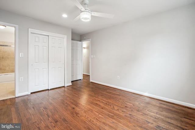 unfurnished bedroom with ceiling fan, a closet, baseboards, and wood finished floors