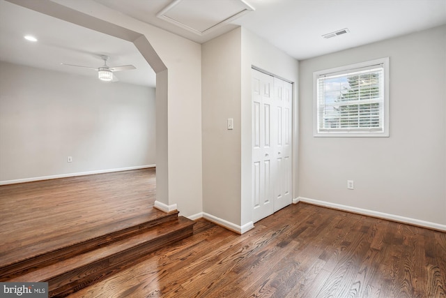 empty room with recessed lighting, wood finished floors, a ceiling fan, visible vents, and baseboards