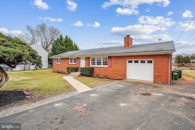 ranch-style home featuring brick siding, a chimney, an attached garage, fence, and a front yard