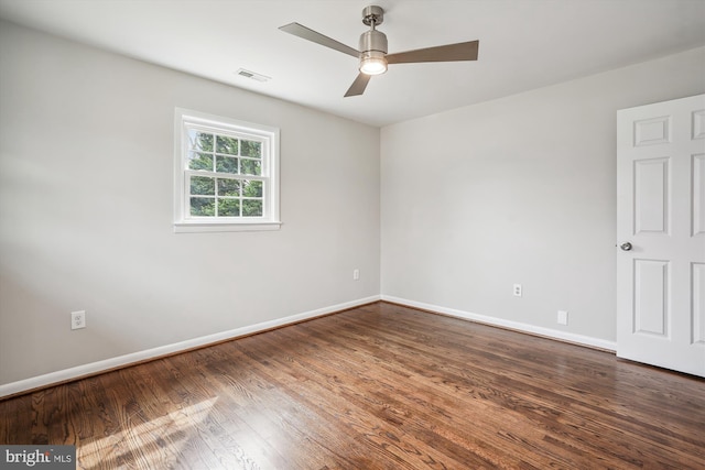 empty room with baseboards, visible vents, ceiling fan, and wood finished floors