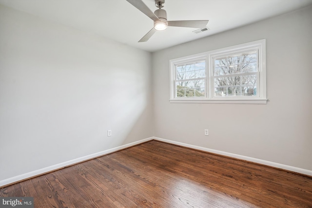 unfurnished room featuring visible vents, ceiling fan, baseboards, and wood finished floors