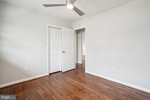 unfurnished bedroom with a closet, wood finished floors, a ceiling fan, and baseboards