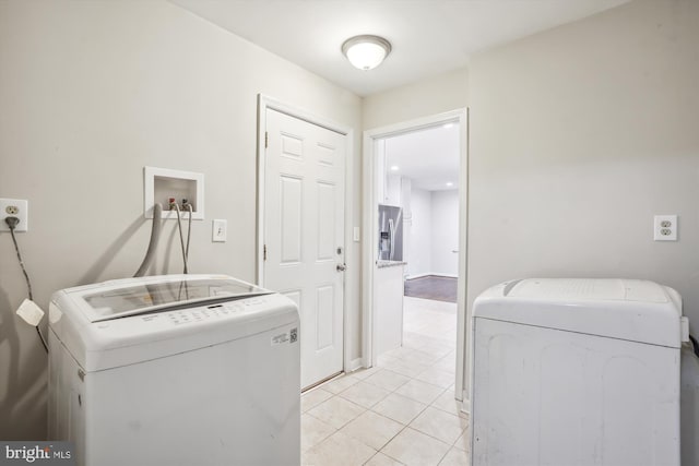 laundry area with laundry area, light tile patterned floors, and washer and dryer