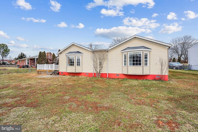 exterior space with crawl space, a deck, and a front lawn