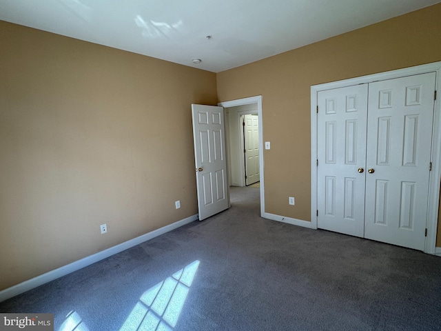 unfurnished bedroom with carpet flooring and a closet