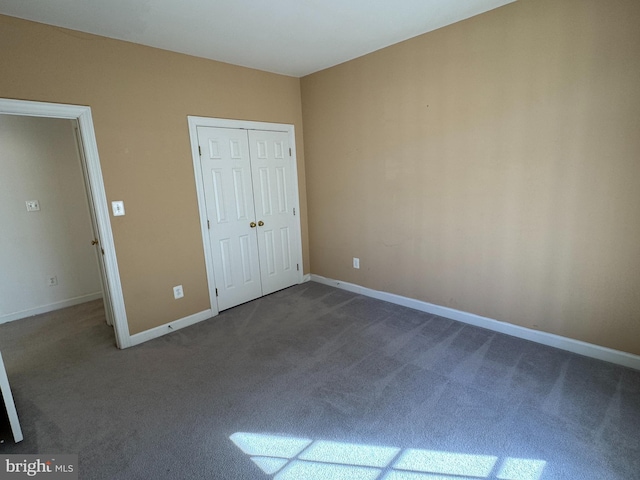 unfurnished bedroom with carpet floors and a closet