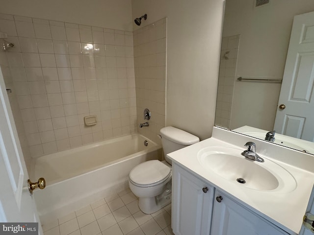 full bathroom with tiled shower / bath combo, vanity, tile patterned flooring, and toilet