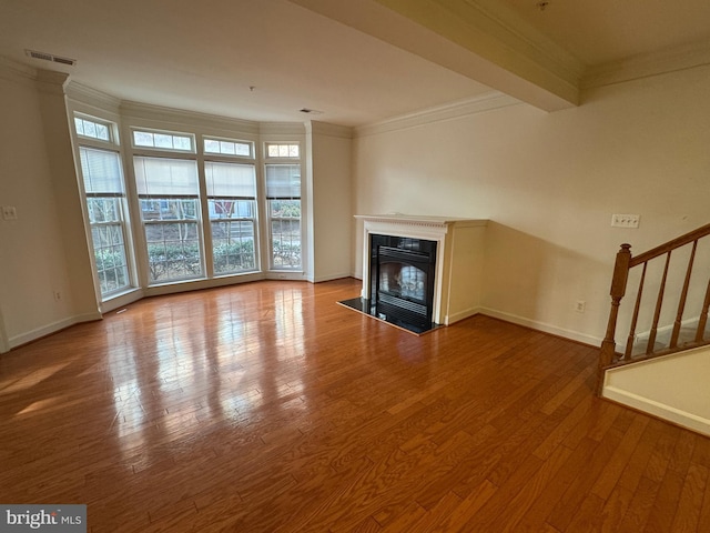 unfurnished living room with crown molding and light hardwood / wood-style flooring