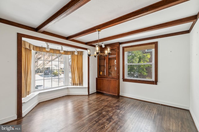 interior space featuring beamed ceiling, plenty of natural light, dark wood-type flooring, and a chandelier