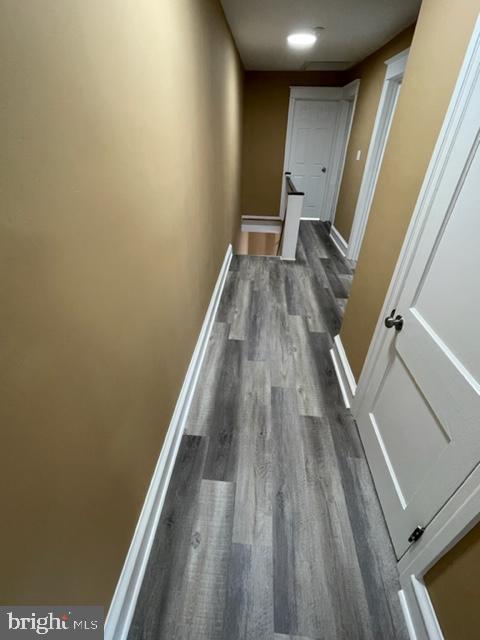 corridor with dark wood-type flooring