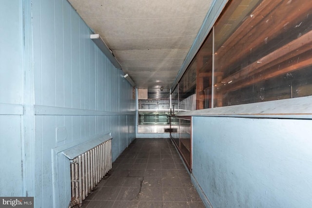 hallway with dark tile patterned floors