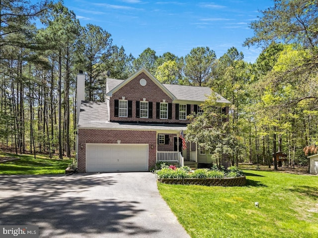 view of front of house featuring a porch, a garage, and a front yard