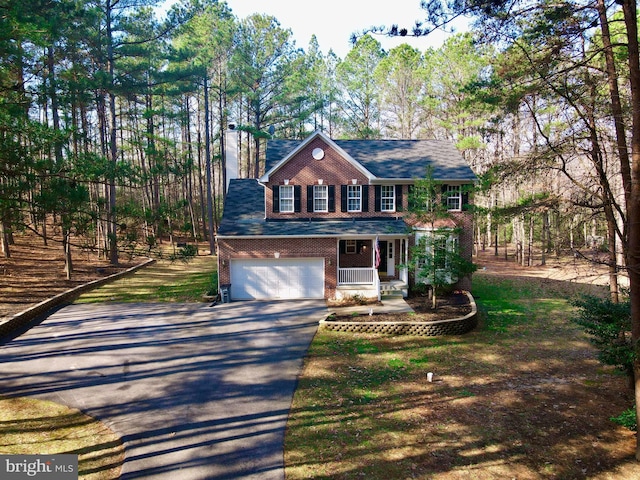 colonial home with a garage and covered porch