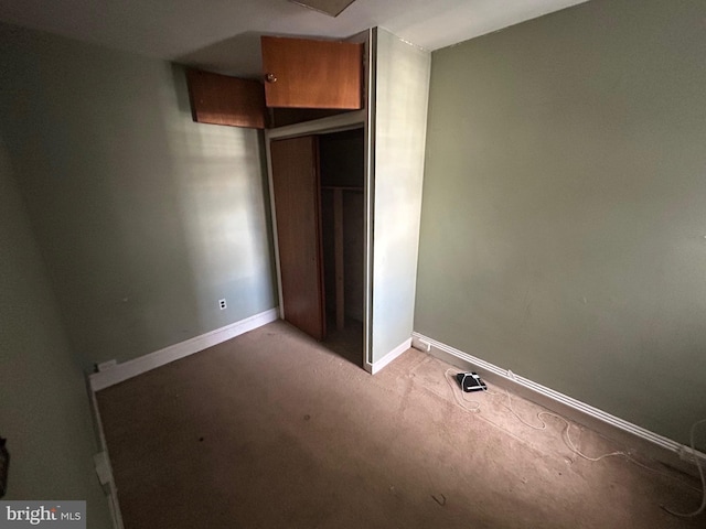 unfurnished bedroom with light colored carpet