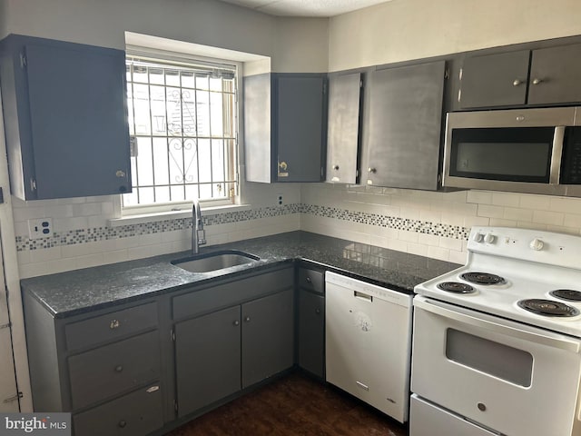 kitchen featuring dishwasher, sink, decorative backsplash, and electric stove