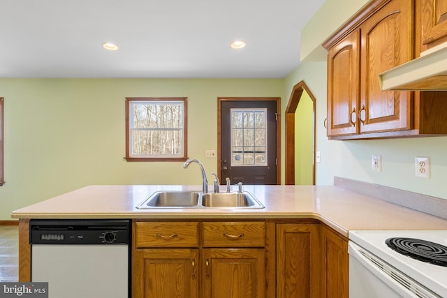 kitchen with sink, white appliances, and kitchen peninsula