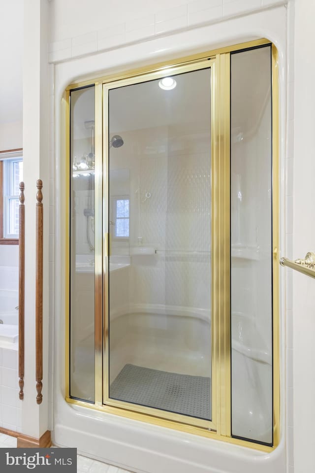 bathroom with a shower with door