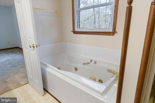 bathroom with a relaxing tiled tub