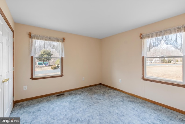 spare room featuring light carpet