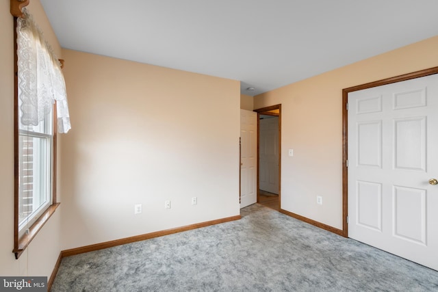 unfurnished bedroom with light colored carpet