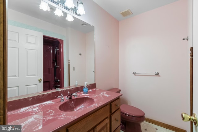 bathroom with vanity and toilet