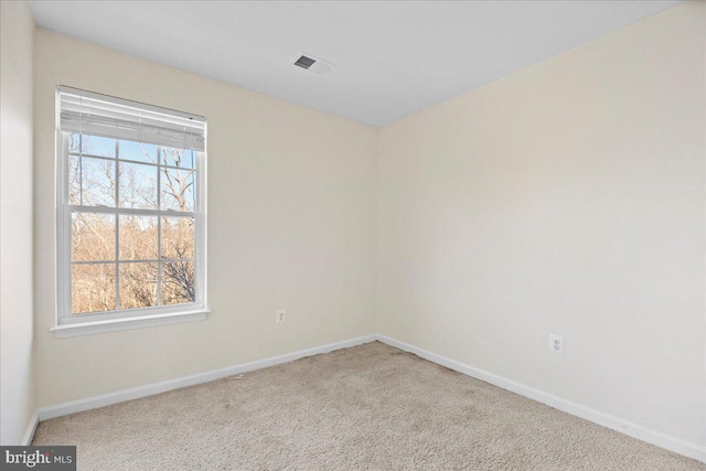 empty room with a healthy amount of sunlight and light carpet