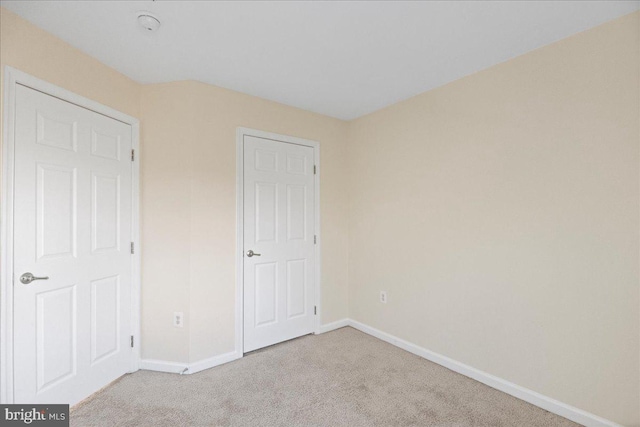 unfurnished bedroom with light colored carpet