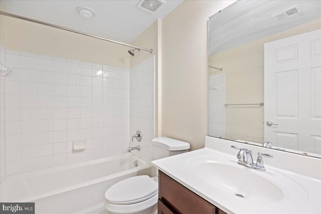 full bathroom featuring tiled shower / bath combo, vanity, and toilet