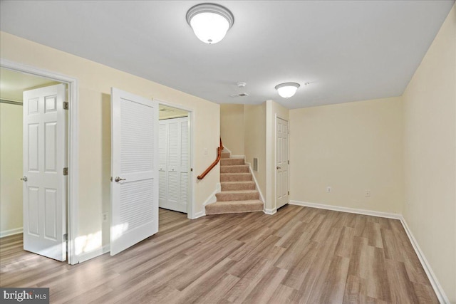 basement with light hardwood / wood-style floors