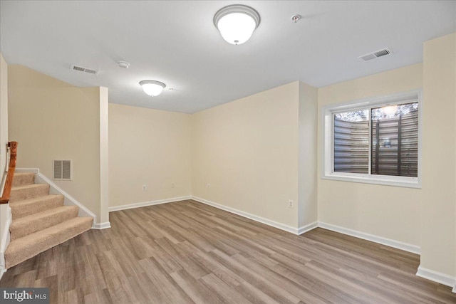 basement with light hardwood / wood-style floors