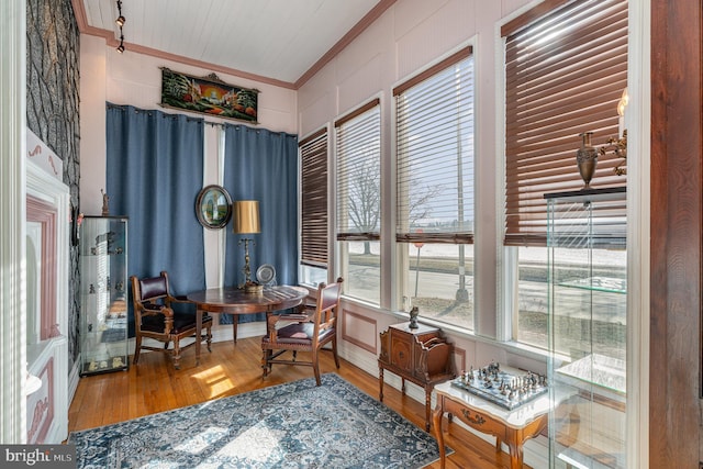 sitting room with hardwood / wood-style flooring and crown molding