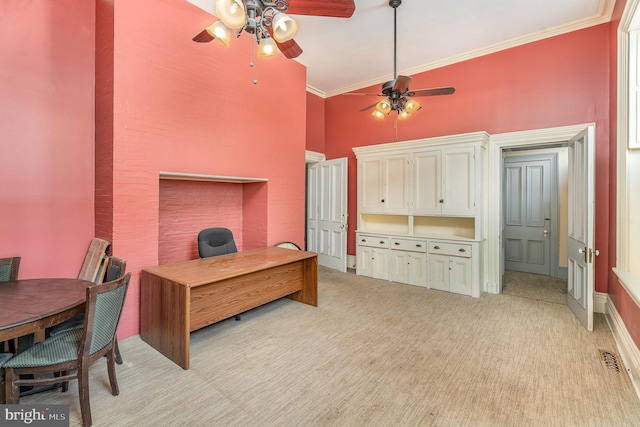 office space with crown molding, ceiling fan, light carpet, and a towering ceiling