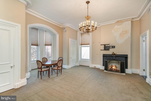 dining area with ornamental molding, plenty of natural light, light colored carpet, and an inviting chandelier