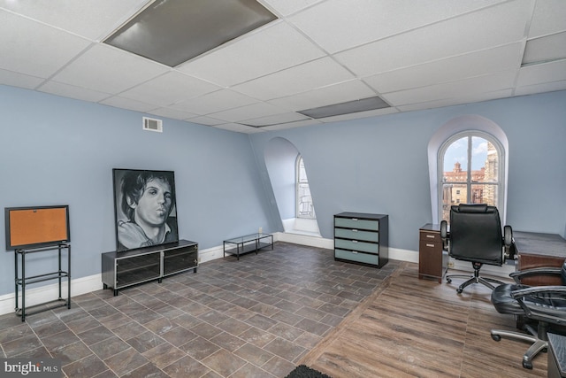 office area with a paneled ceiling